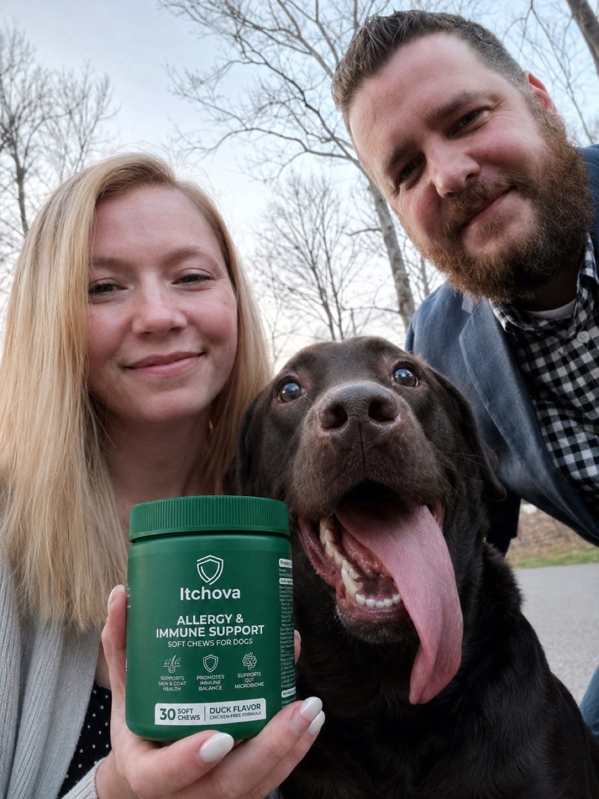 Dog parents outdoors with their dog and an Itchova jar